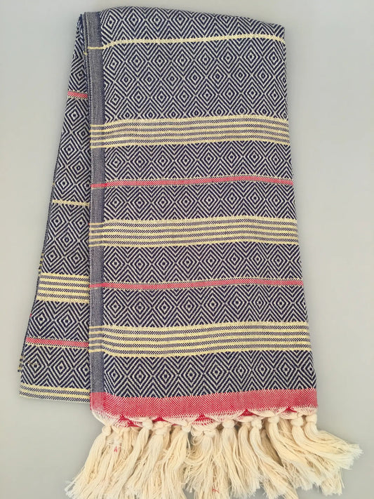 "Lycia Xanthos Turkish towel peshtemal in blue and white diamond pattern with red and cream stripes, fringed edges."