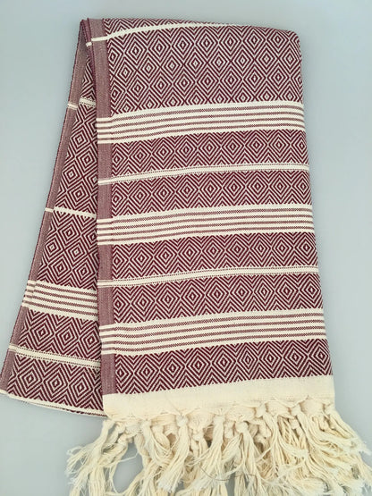 "Lycia Xanthos Turkish towel peshtemal in burgundy and cream with diamond patterns and fringed edges, folded view"